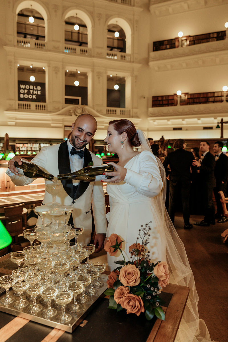 Newlyweds pouring champagne tower