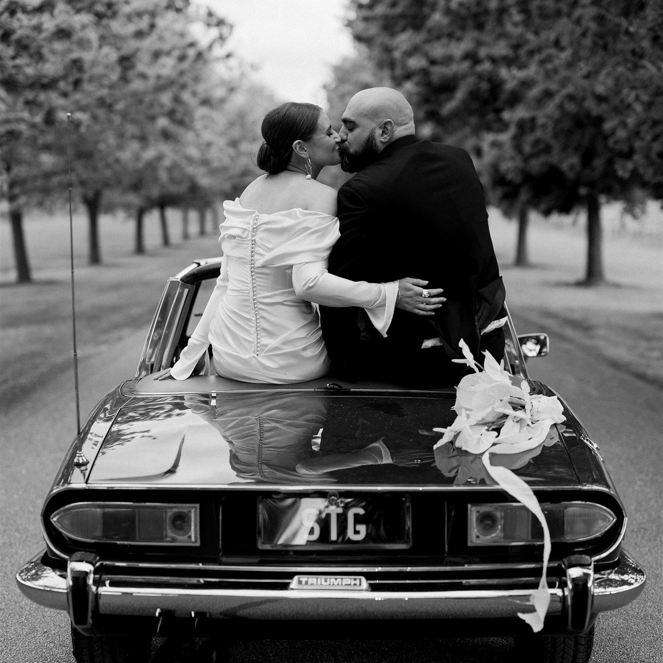 Couple riding wedding car