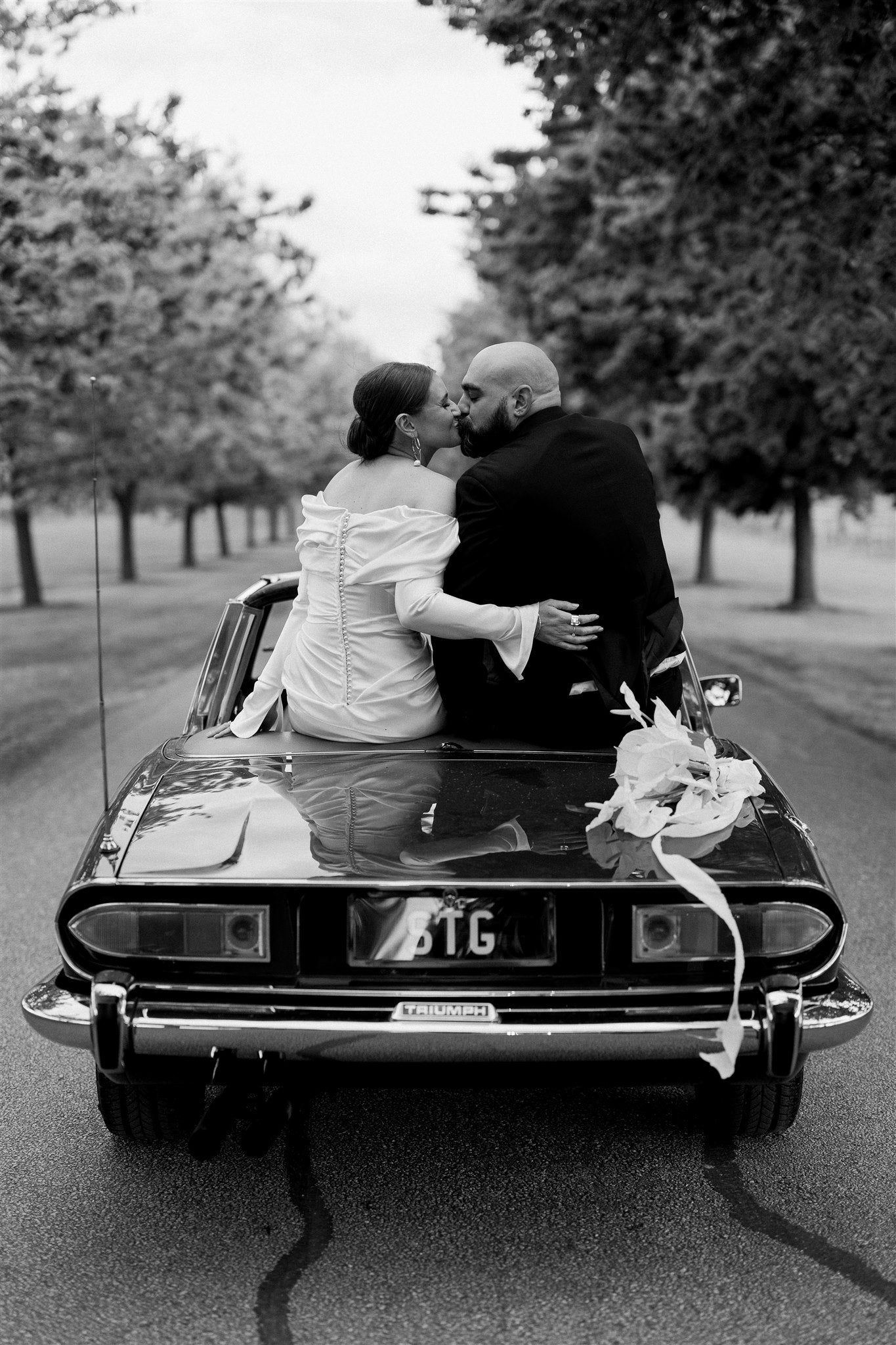 Couple riding wedding car