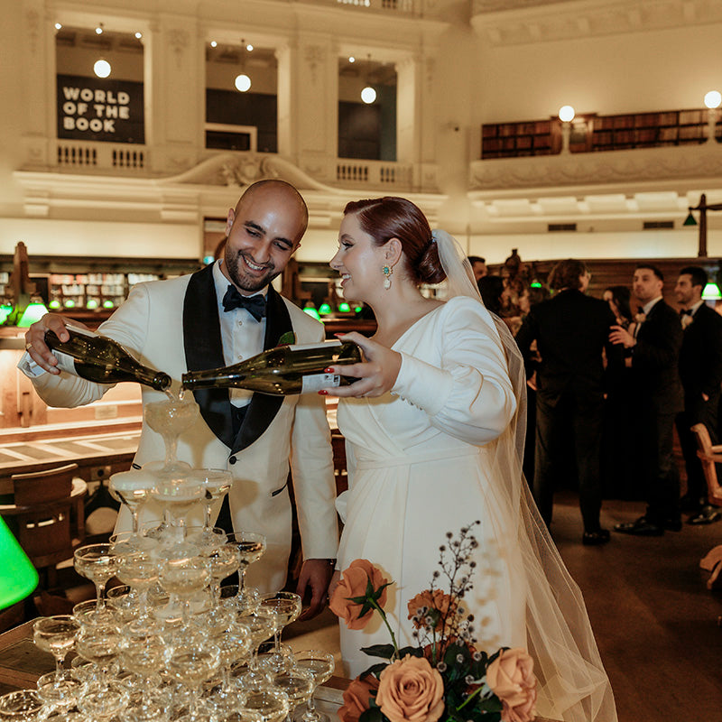 Newlyweds pouring champagne tower