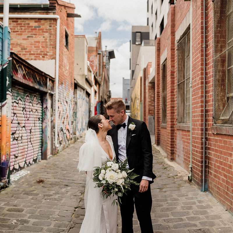 Couple standing in alley at wedding
